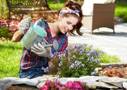 Gardener working with tools in a residential garden in Hanwell
